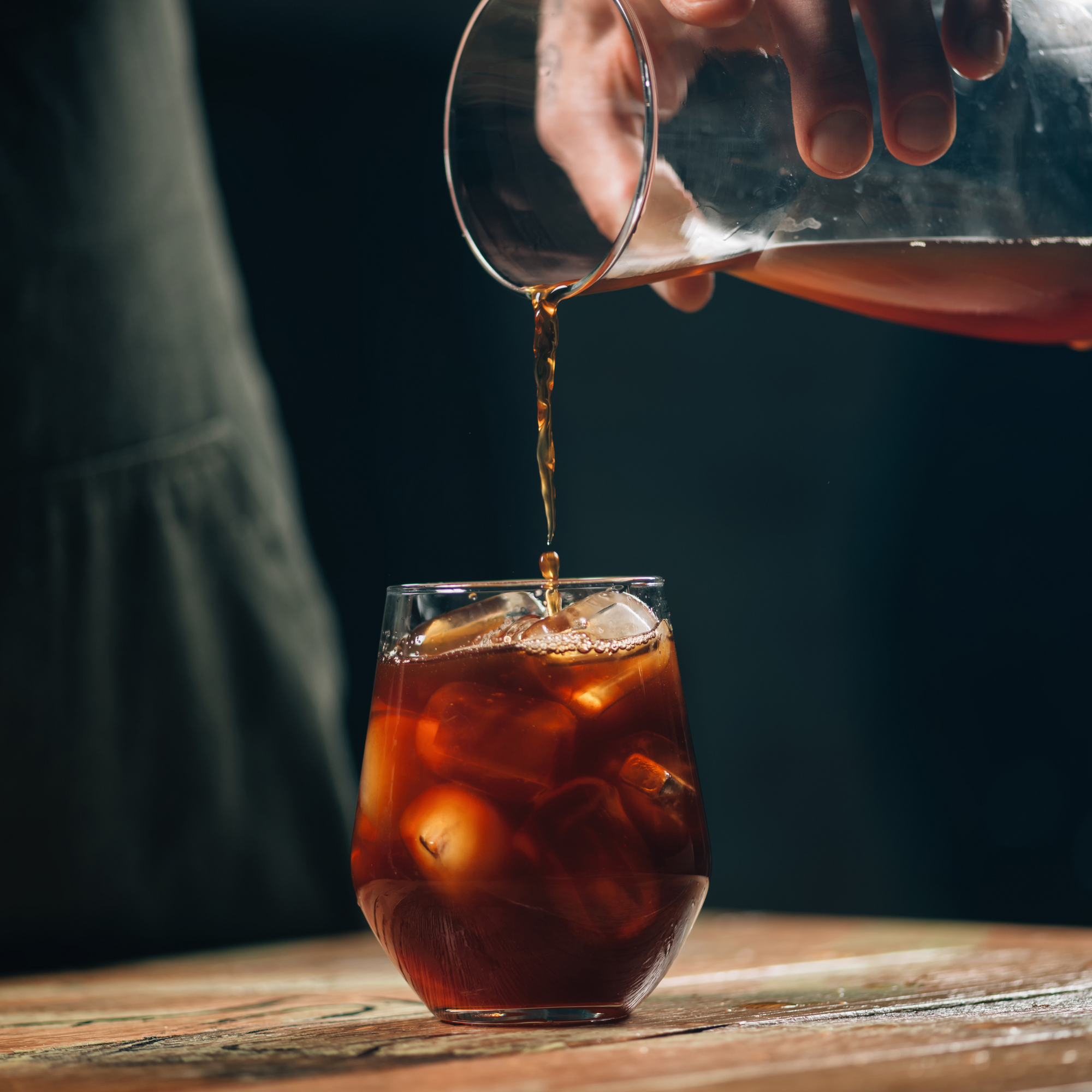 Specialty coffee beans and &Better's personal care products, symbolizing the shared philosophy of quality, natural essence, and a commitment to conscious living.