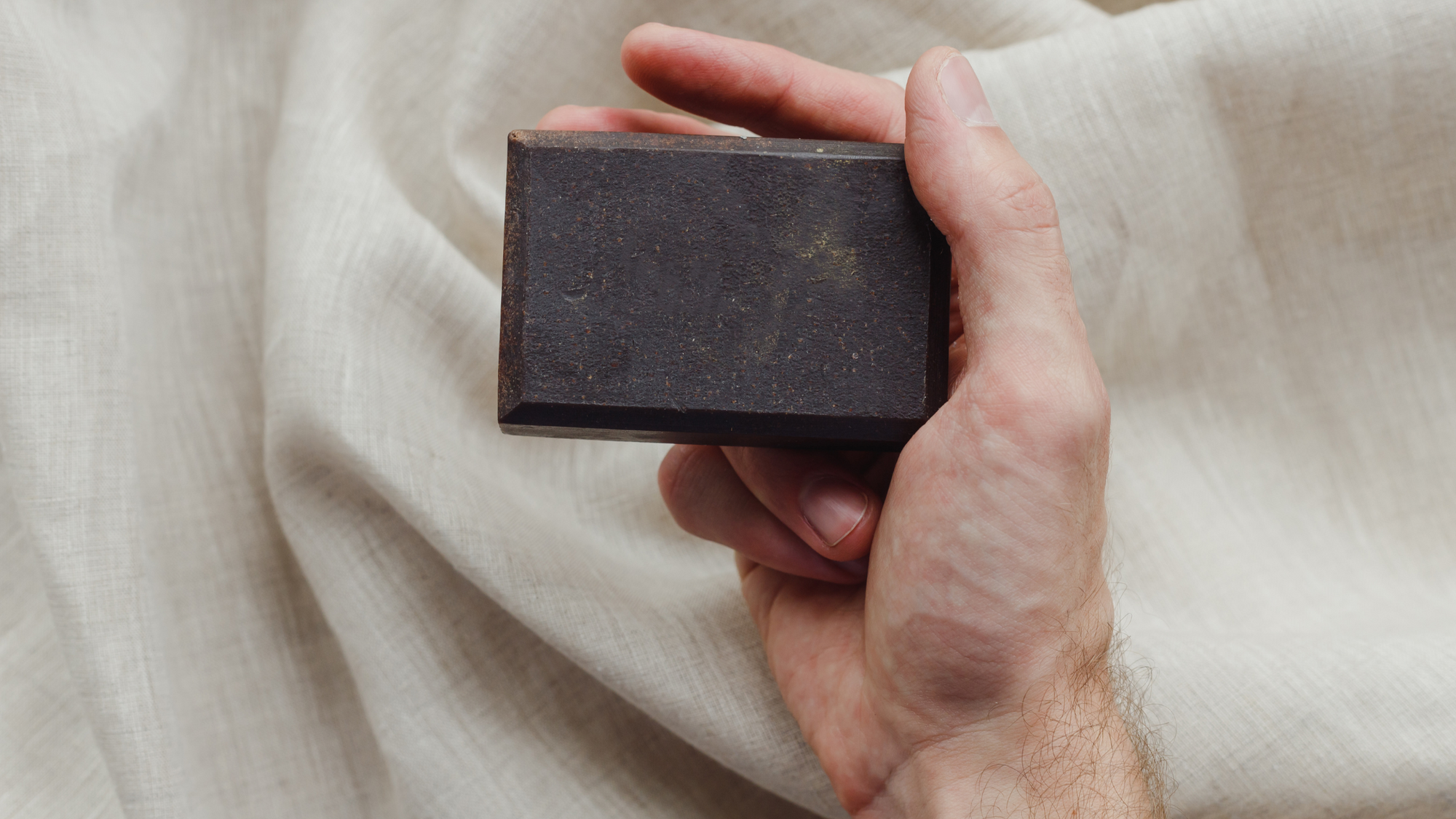 Woman holding &Better natural soap bar, promoting eco-friendly, non-toxic personal care products ideal for new parents