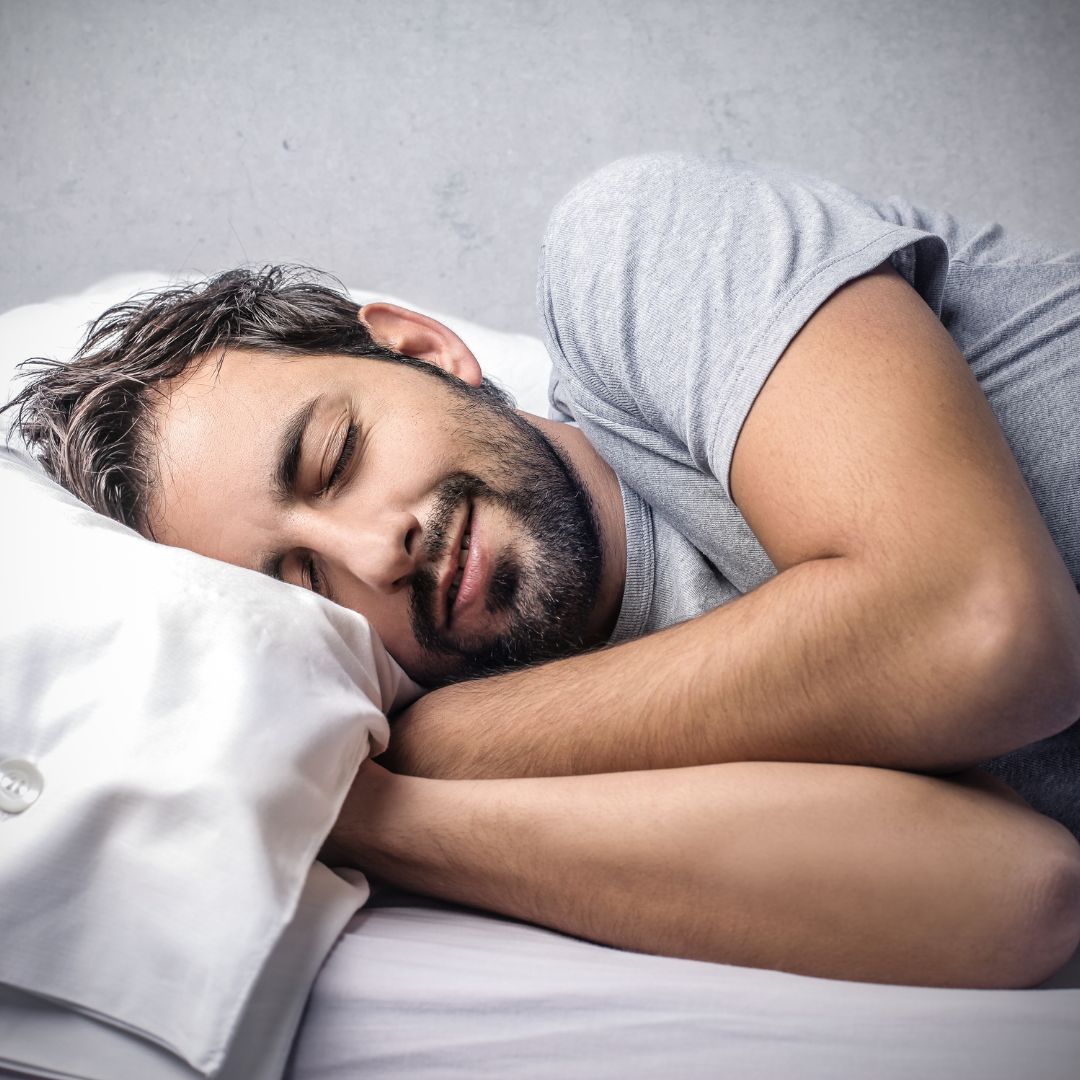 A young adult man peacefully sleeping in a horizontal position